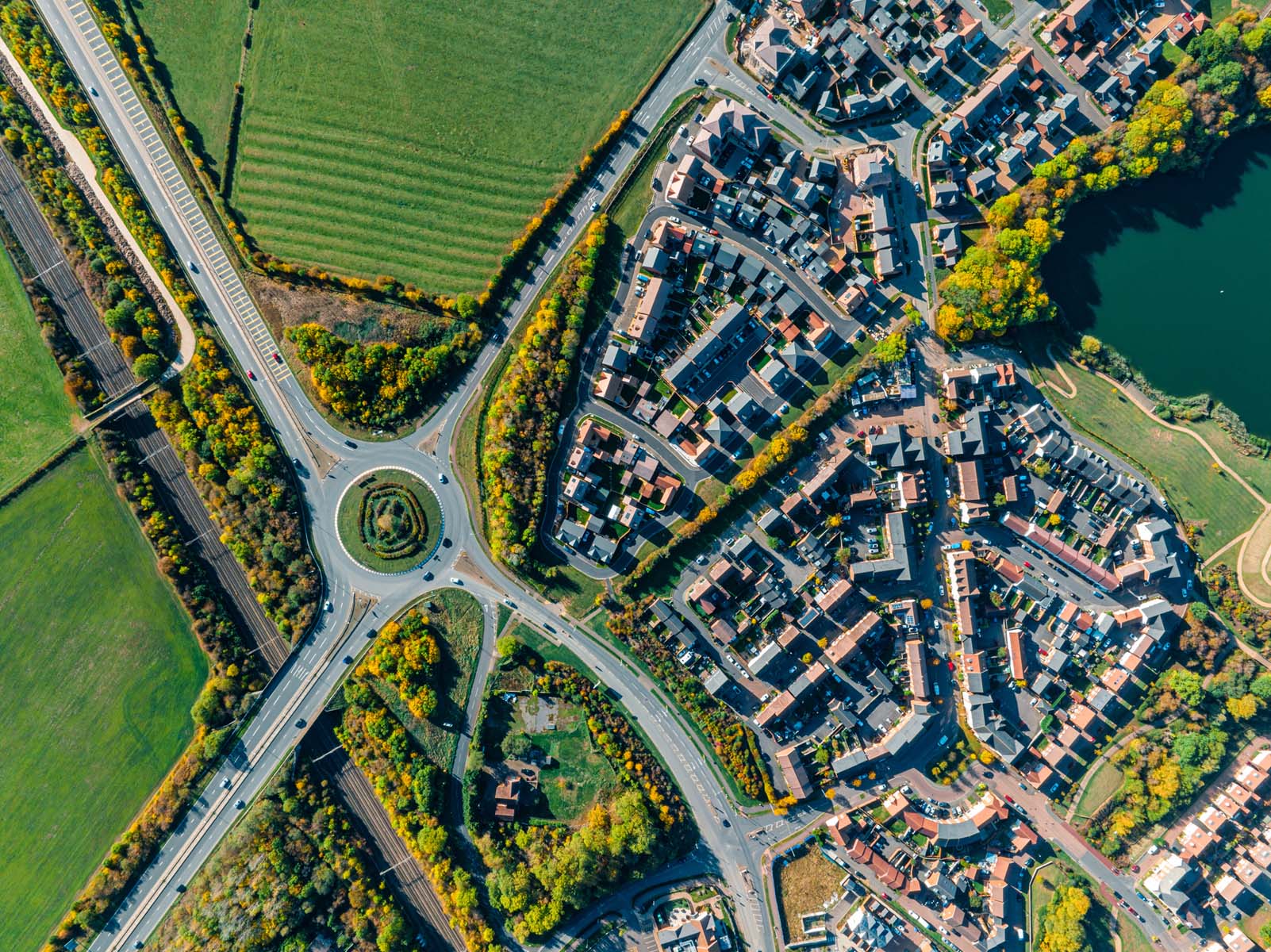Aerial view of UK roundabout and residential area.